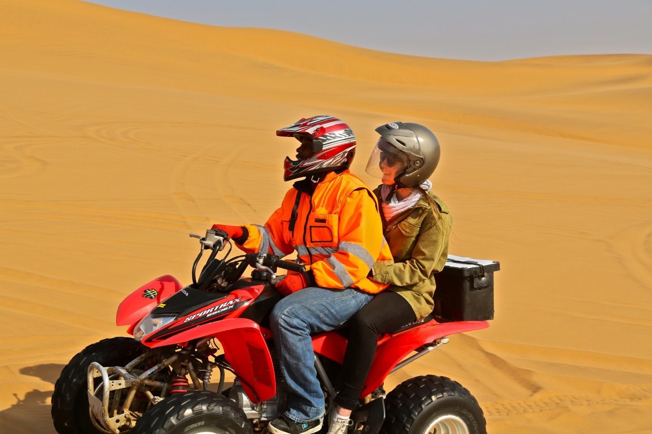 Quadbiker riding in the dunes