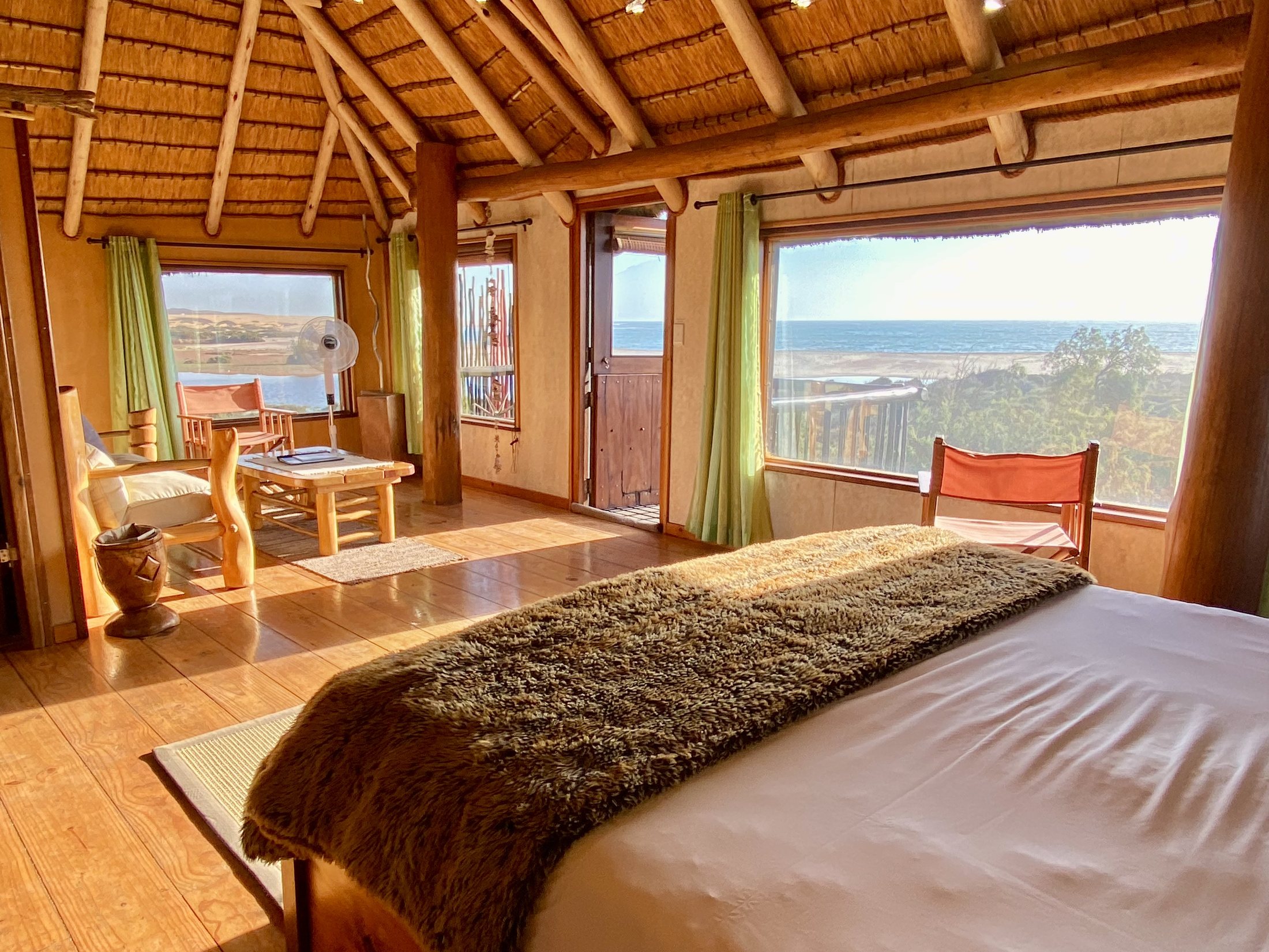 Bungalow bedroom opening toward the ocean-view balcony