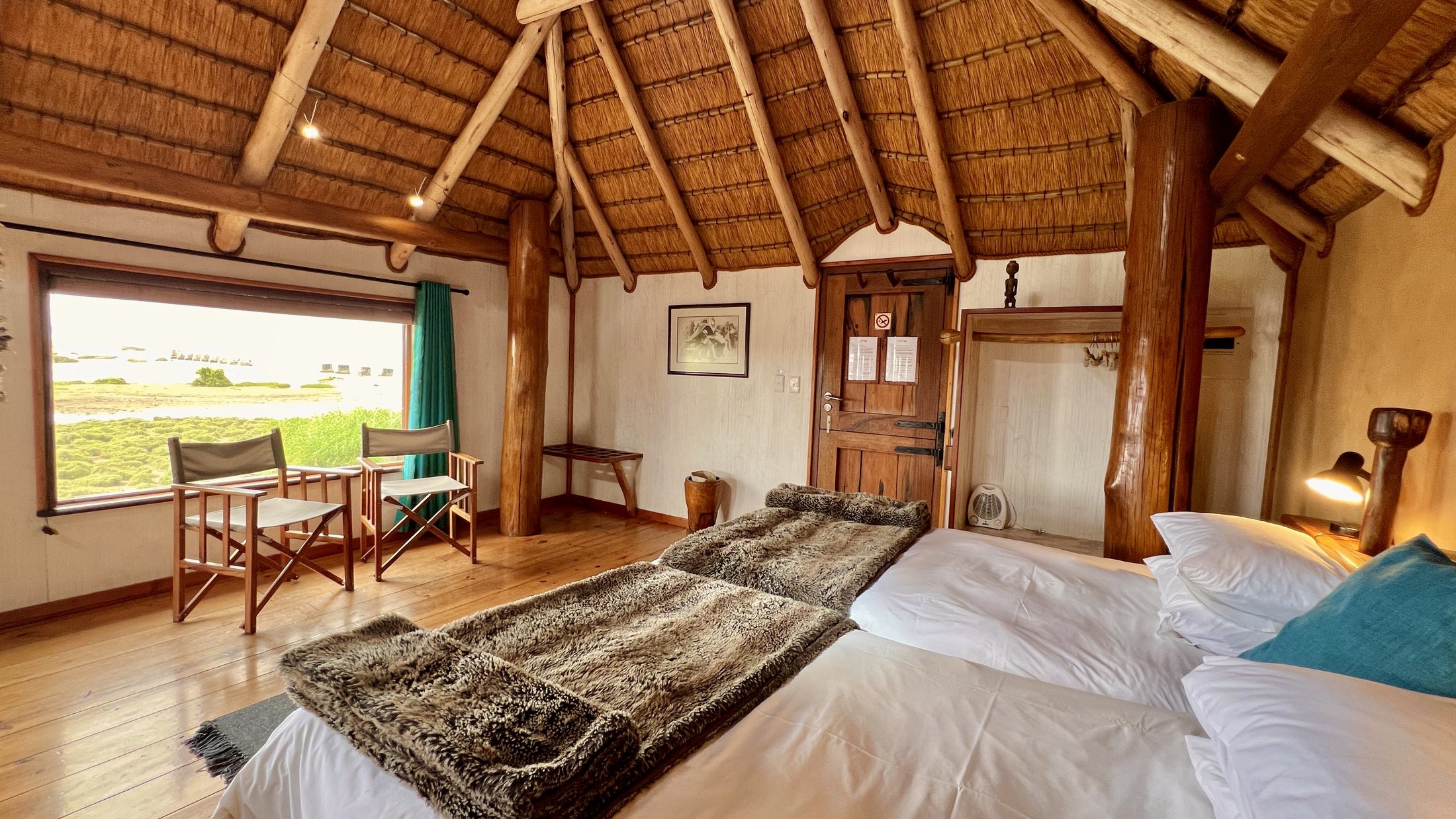 Double bungalow bedroom with balcony table and lagoon views