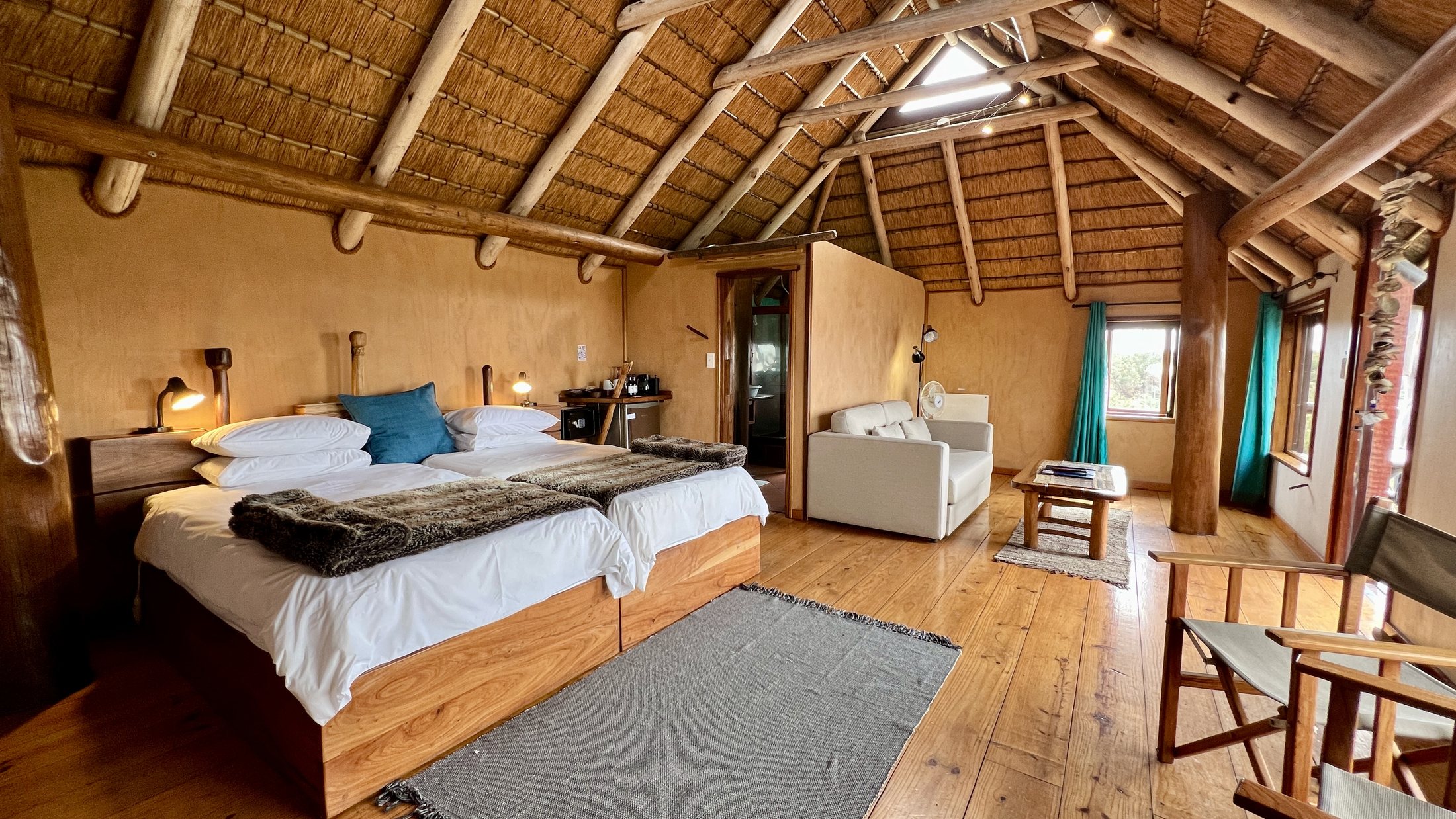 Spacious family bungalow twin bedroom with warm timber finishes