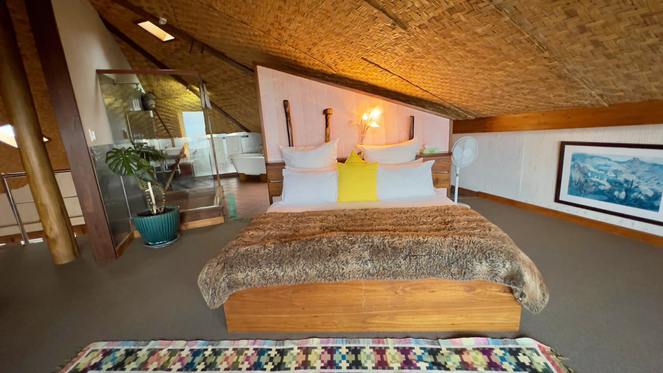Villa upstairs bedroom with warm yellow accents