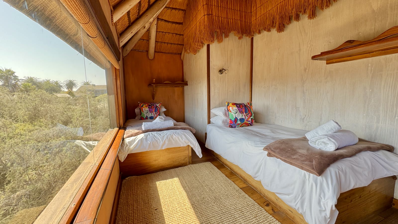 Family Bungalow twin bedroom beside a large nature-facing window