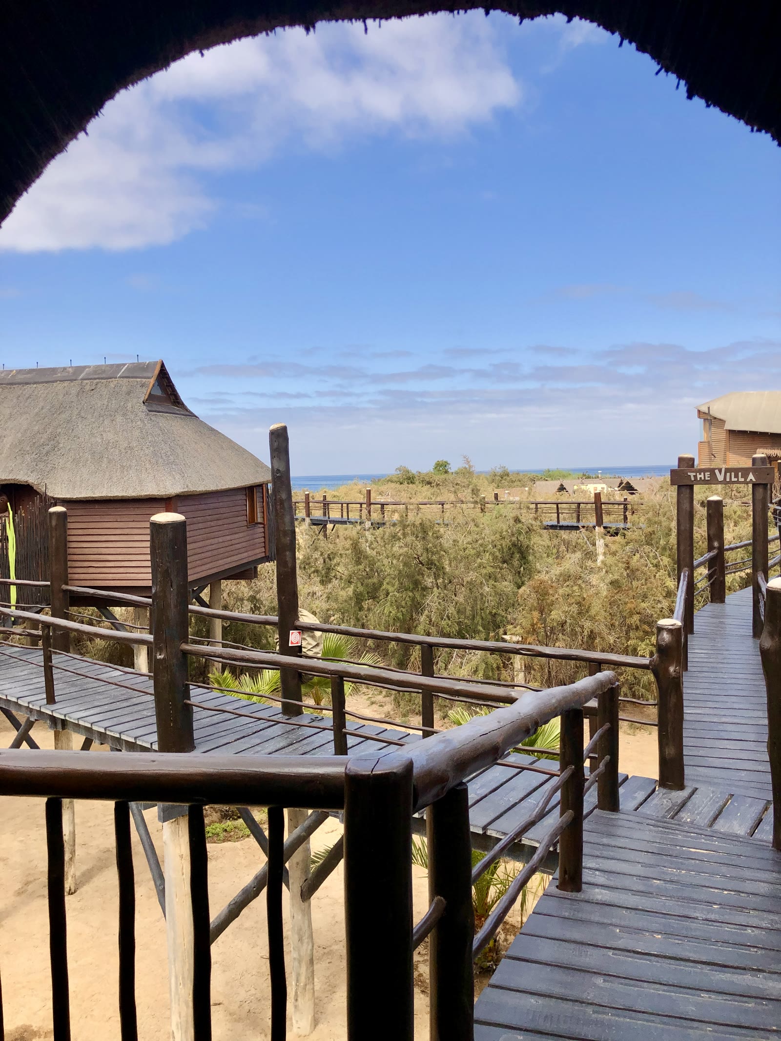 Raised walkway leading toward The Villa with an ocean view