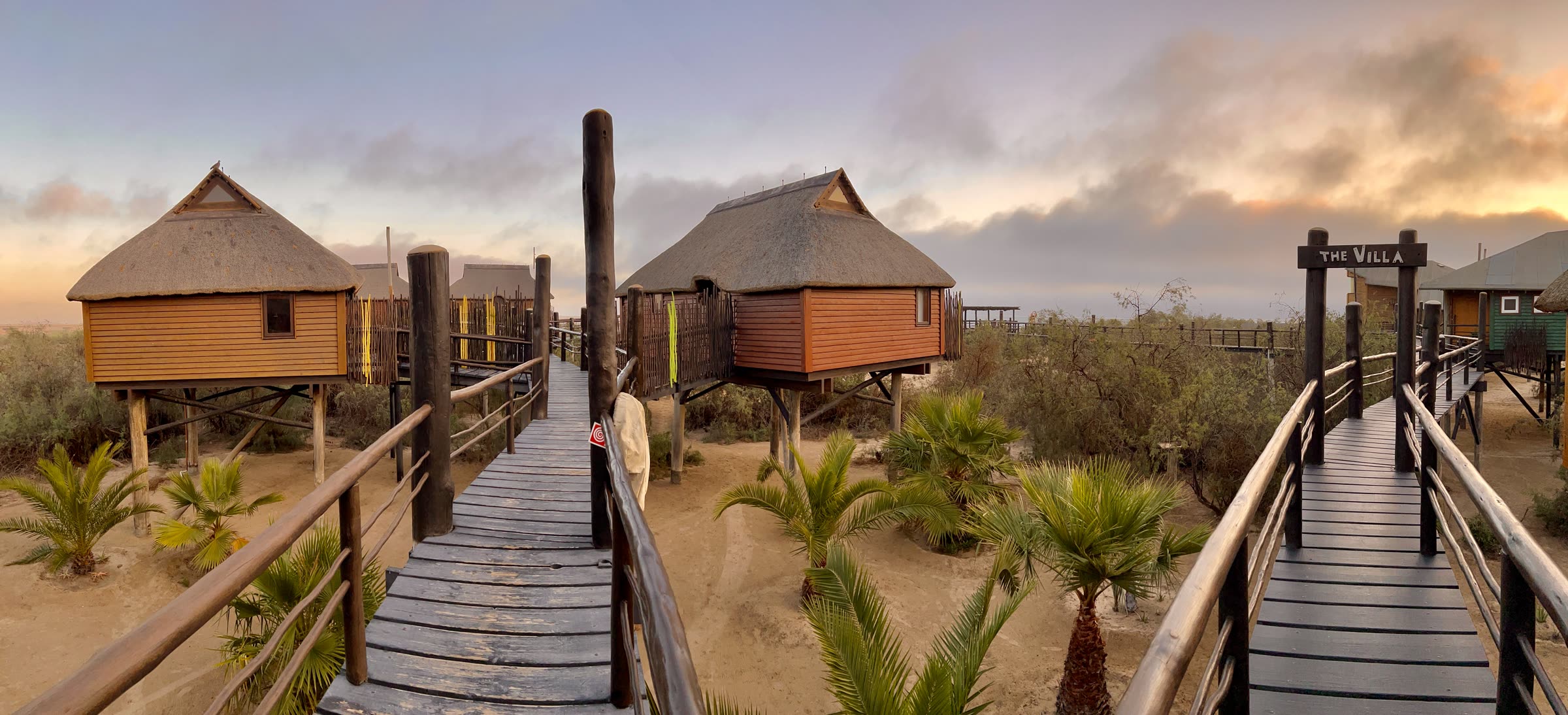 Sunset panorama of The Stiltz bungalows and raised walkways