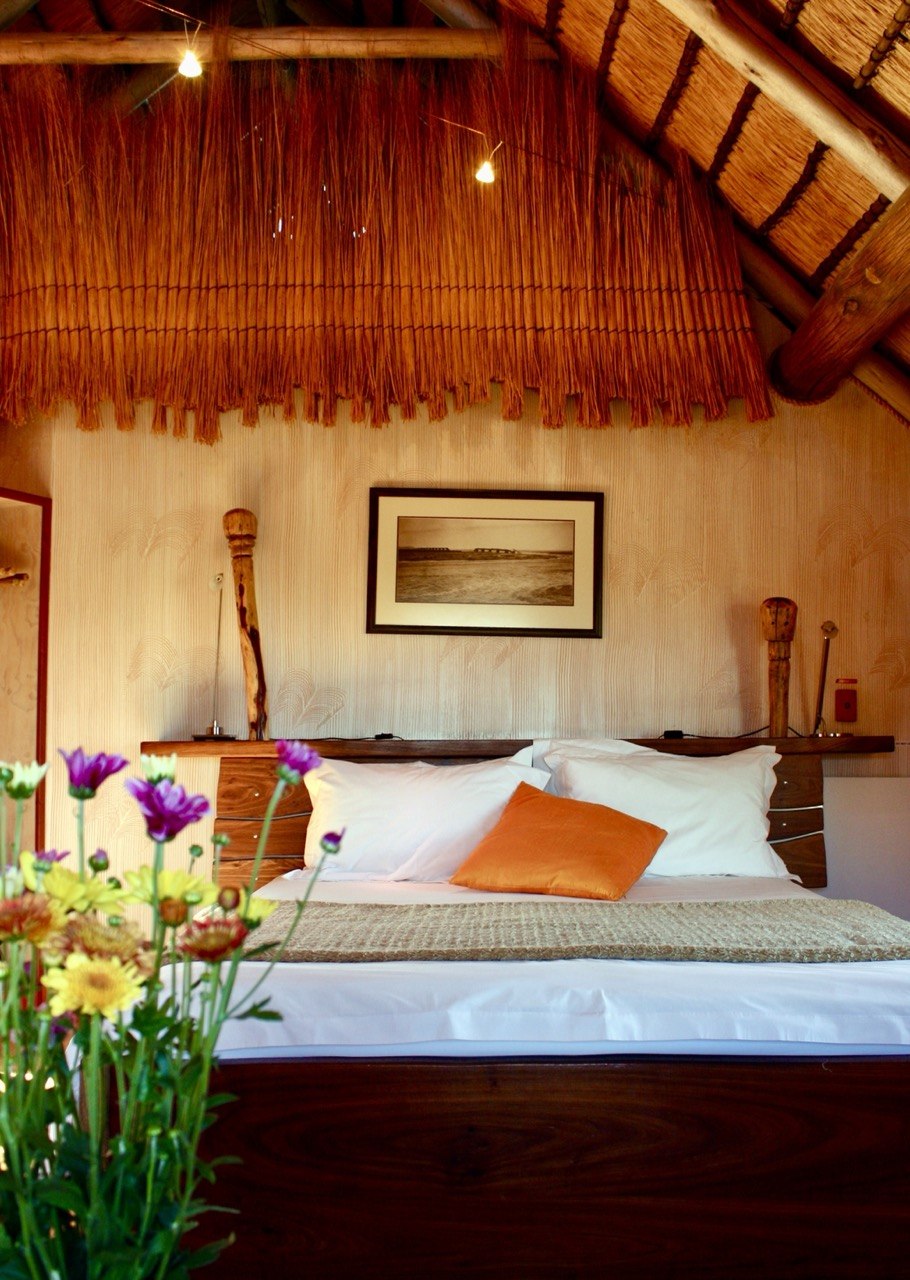 The Stiltz bungalow bedroom with flowers in the foreground