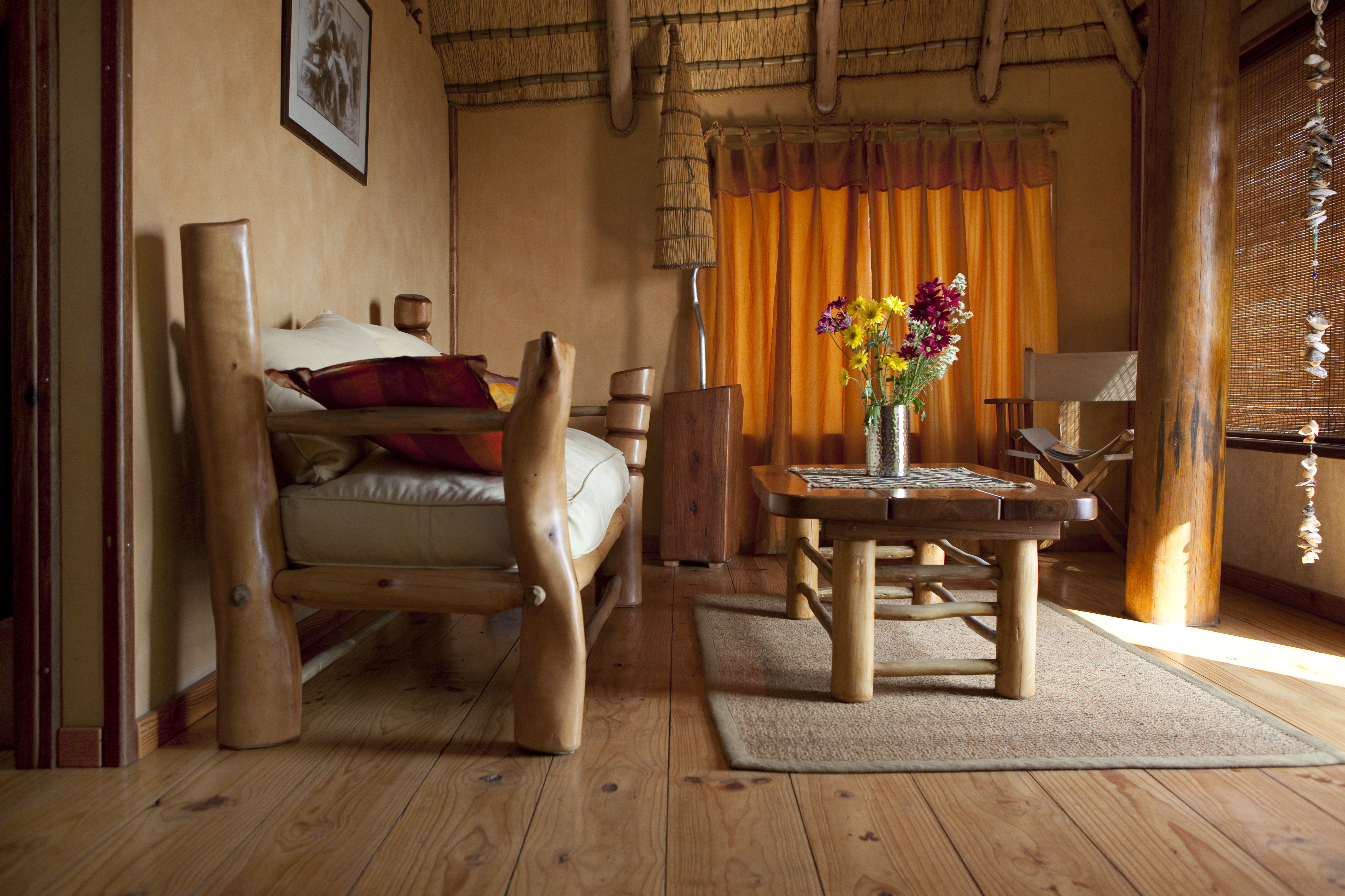 The Stiltz bungalow interior with lounge seating and warm light