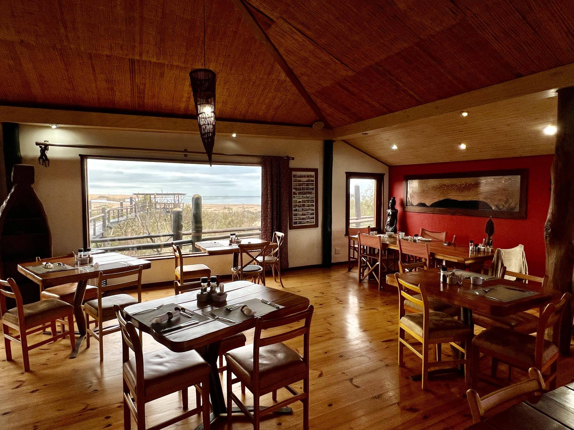 Dining room breakfast tables with sea views at The Stiltz