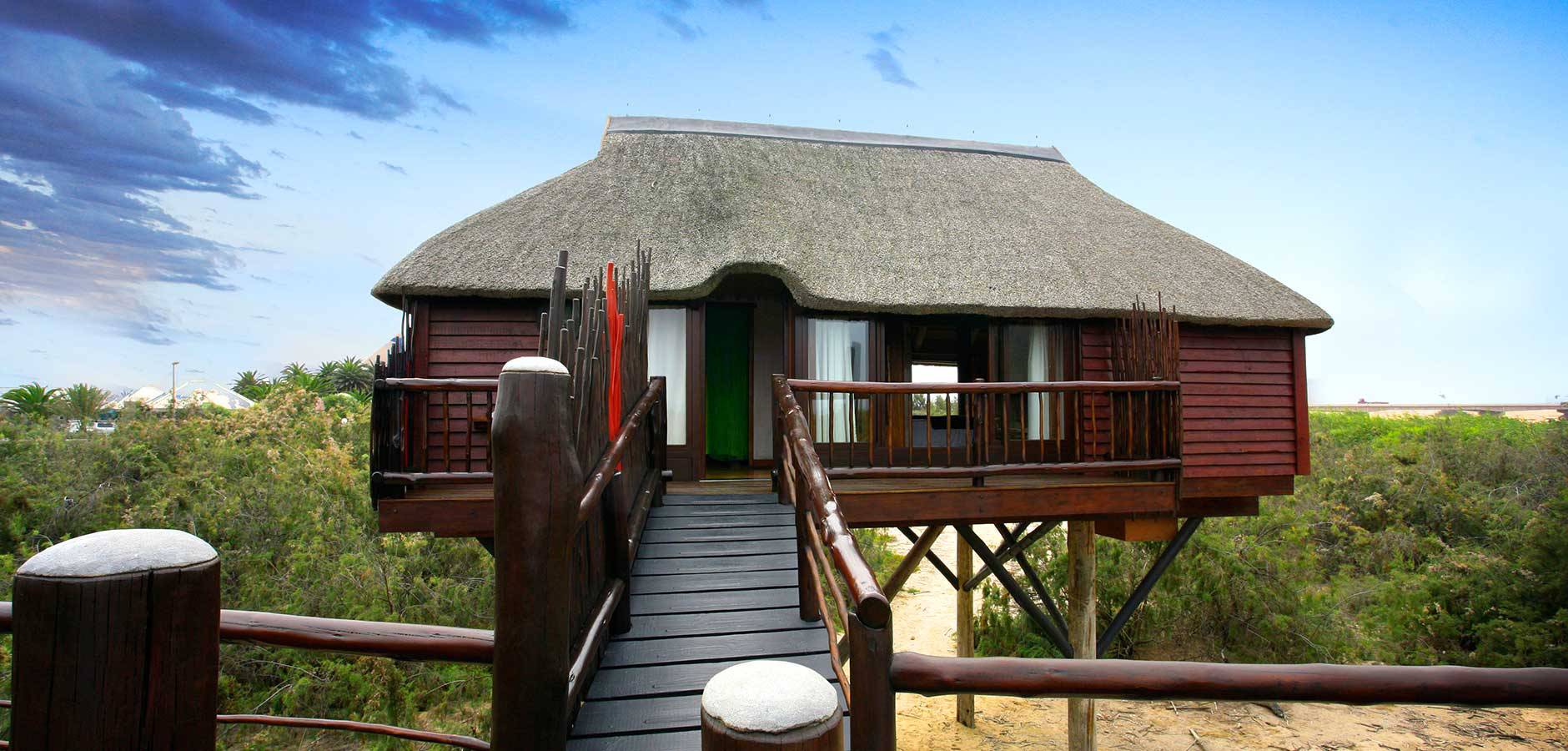 The old The Stiltz website hero image showing the lodge bungalow and lagoon